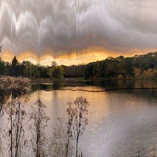 Melting plastic sunset over lake in late fall