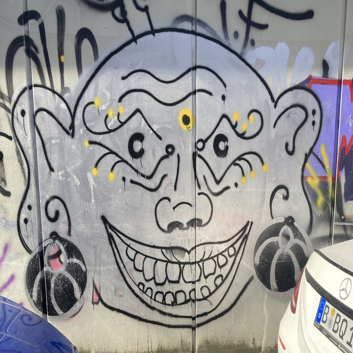 A demon's head graffiti drawing on a wall